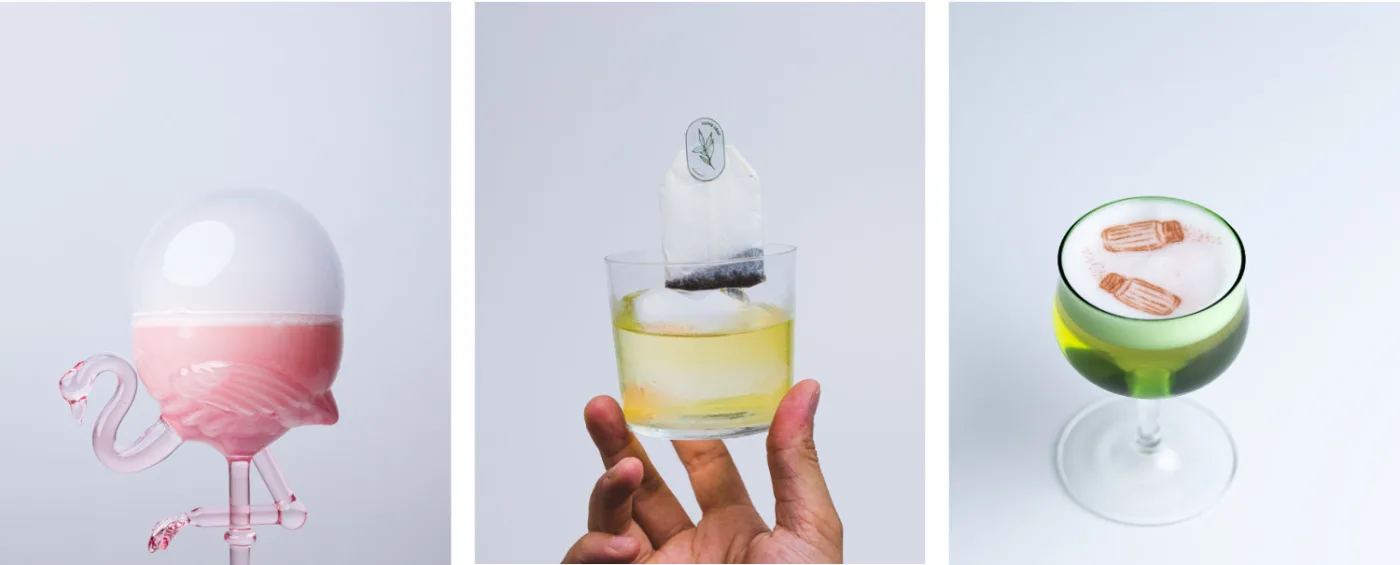 Tre cocktail progettati da Jessy Santin per cocktail competition: a sinistra un cocktail rosa in un bicchiere di vetro a forma di fenicottero con una bolla di fumo, al centro un cocktail al tè in un tumbler basso con un chunk di ghiaccio e una bustina di tè, a destra un cocktail verde con foam decorata da una stampa commestibile di due spargisale