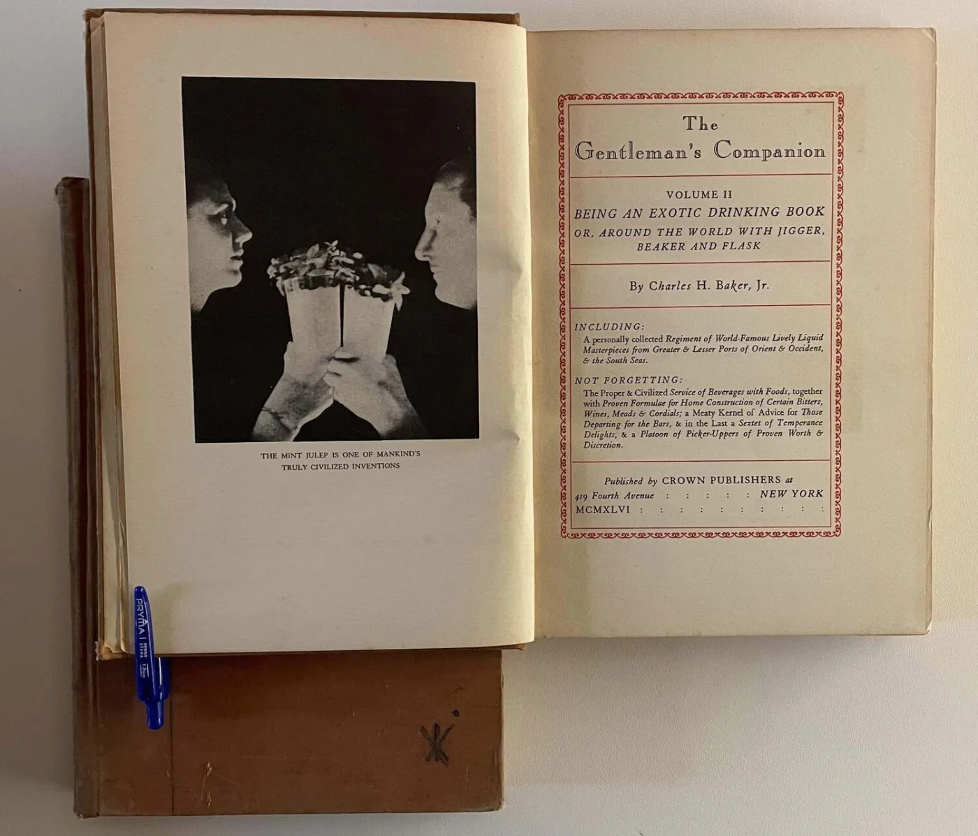 Il frontespizio di The Gentleman's Companion Volume II di Charles H. Baker Jr., aperto accanto a una foto del Mint Julep